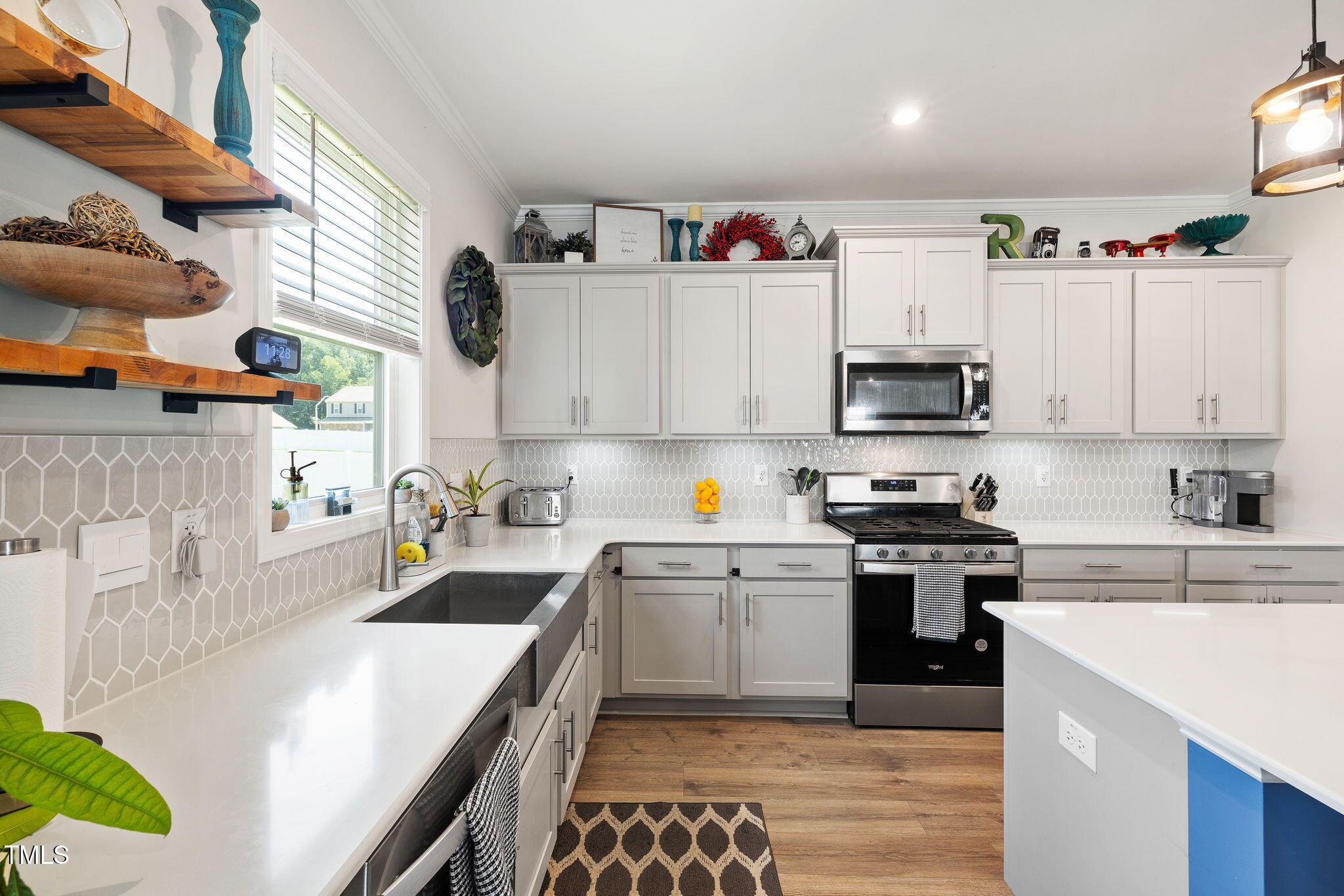 95 Madden Rose Loop Garner, NC 27529 - Photo 21 of 51 a kitchen with granite countertop a sink a stove top oven and cabinetry