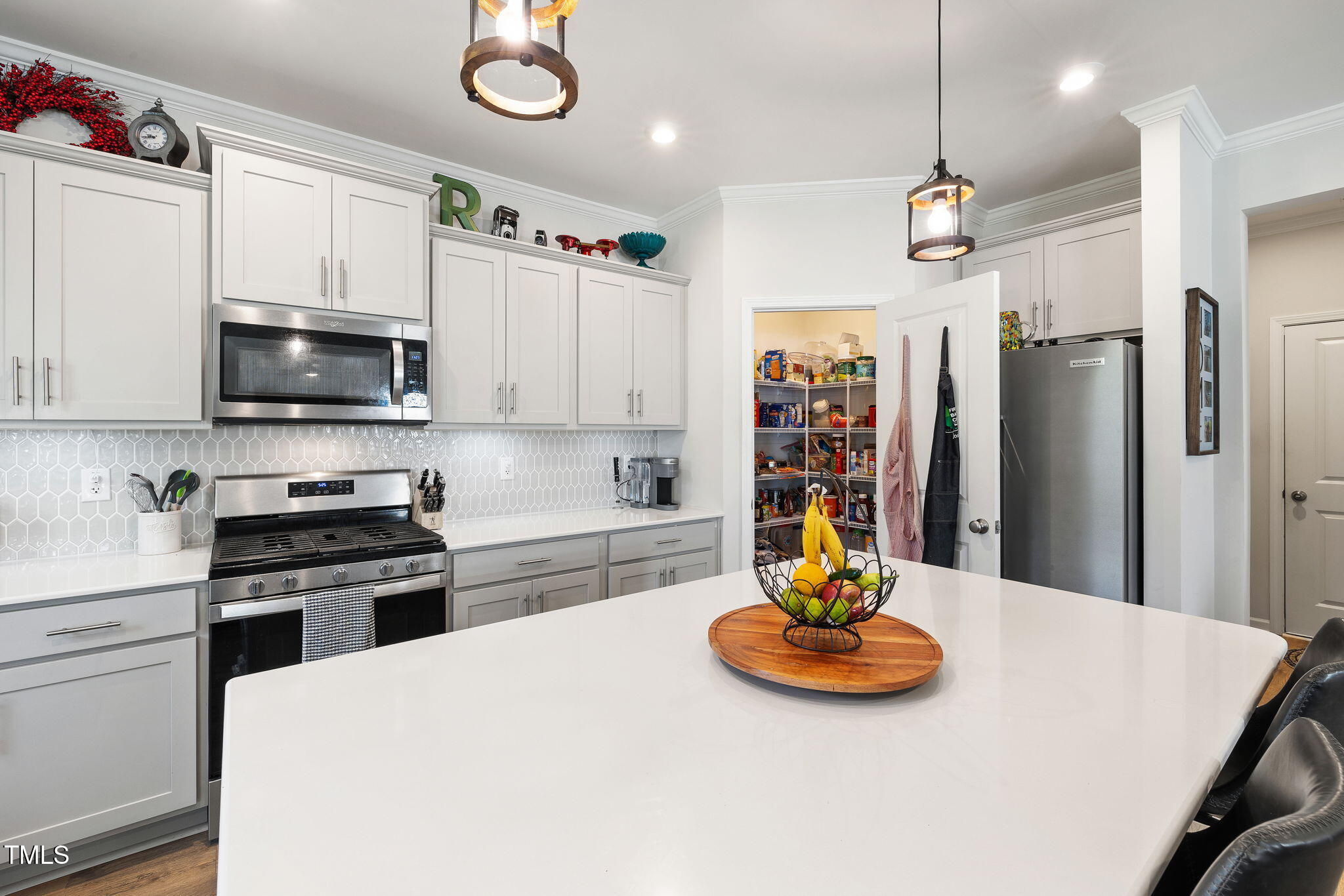 95 Madden Rose Loop Garner, NC 27529 - Photo 22 of 51 a kitchen with stainless steel appliances a table chairs and a refrigerator
