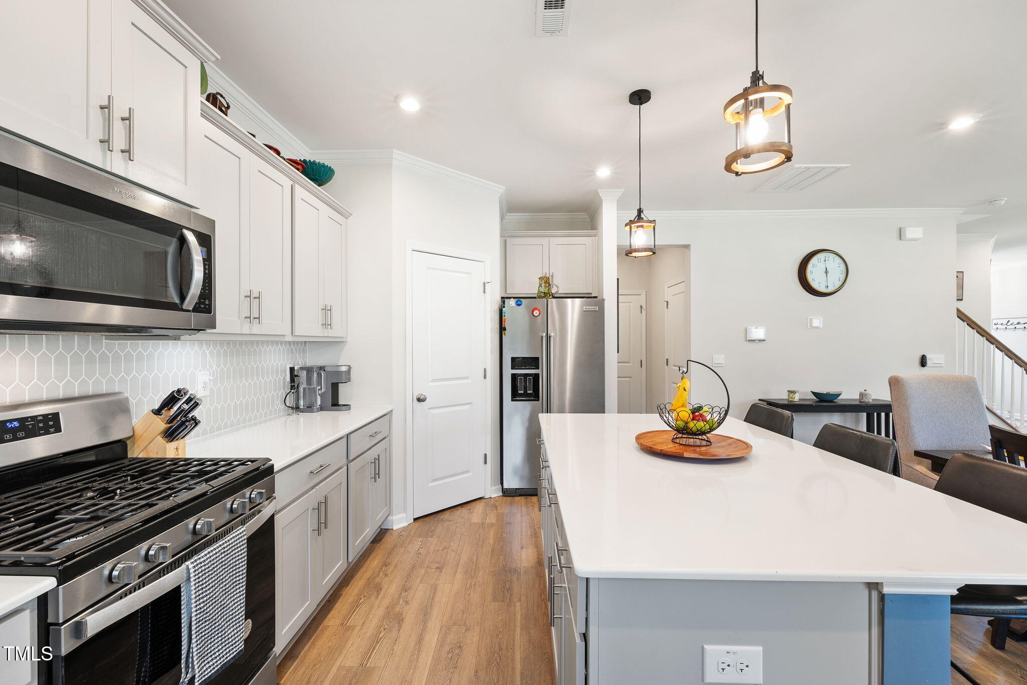 95 Madden Rose Loop Garner, NC 27529 - Photo 23 of 51 a kitchen with a sink a stove and chairs
