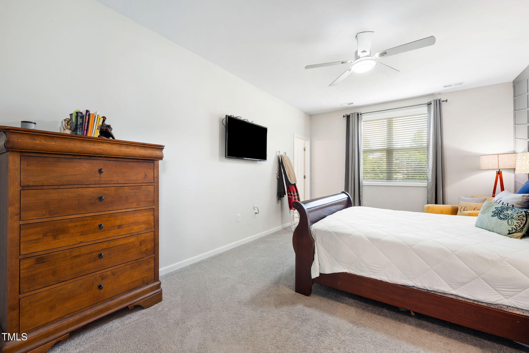 95 Madden Rose Loop Garner, NC 27529 - Photo 31 of 51 a bedroom with a bed and a flat tv screen on dresser