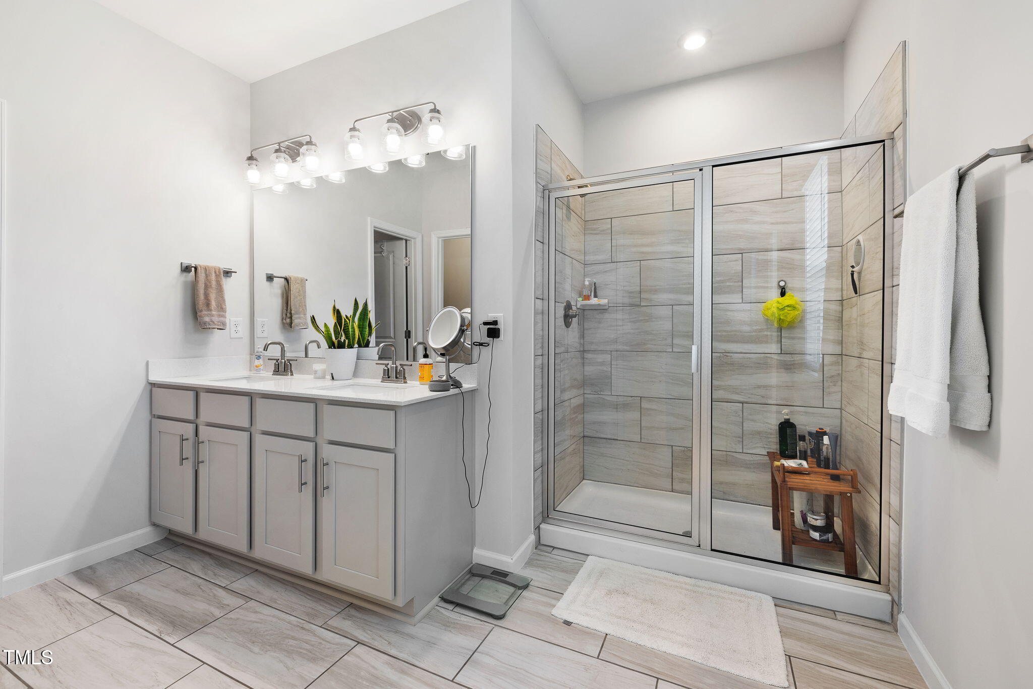 95 Madden Rose Loop Garner, NC 27529 - Photo 32 of 51 a bathroom with a double vanity sink and shower