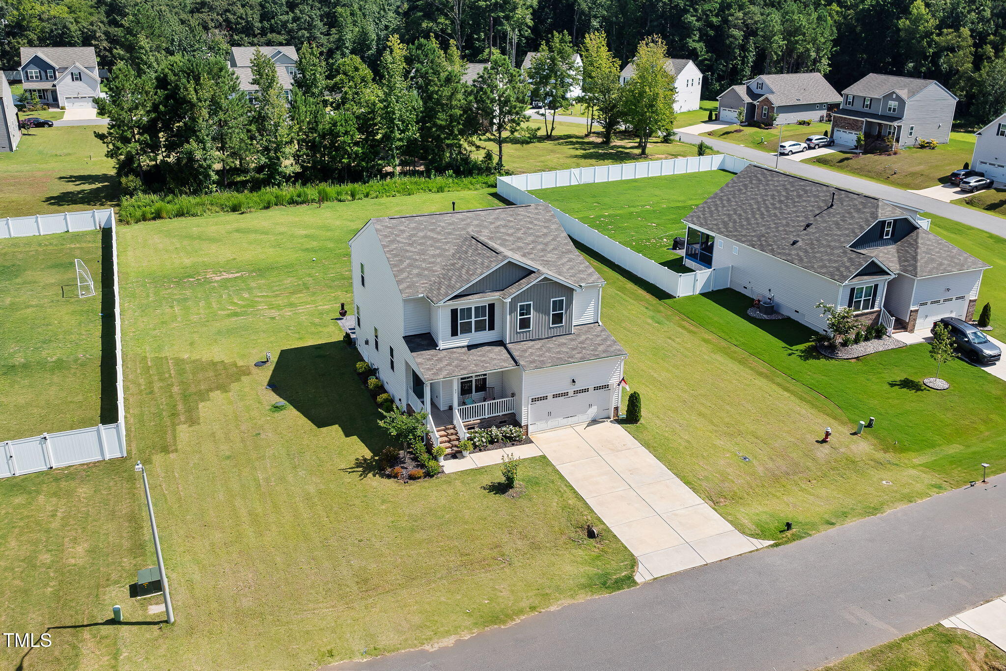 95 Madden Rose Loop Garner, NC 27529 - Photo 4 of 51 an aerial view of a house with a garden and swimming pool