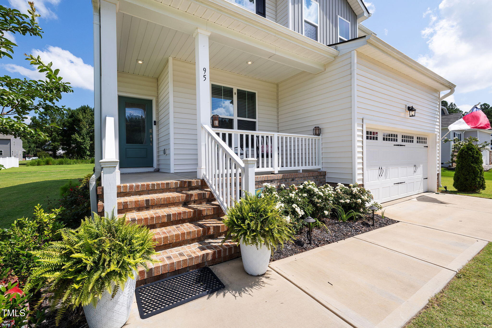 95 Madden Rose Loop Garner, NC 27529 - Photo 7 of 51 a potted plant sitting in front of a house