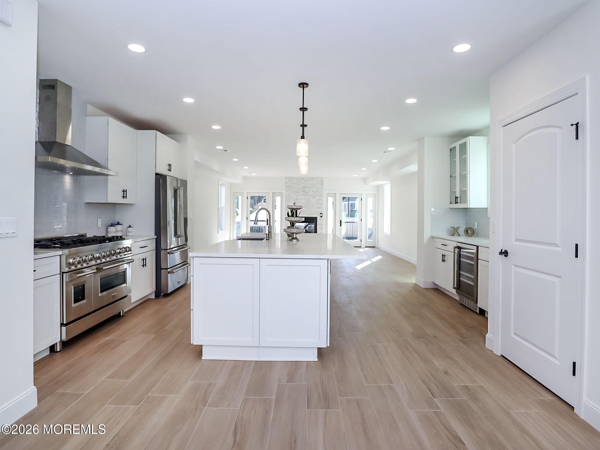 22 Marion Street Red Bank, NJ 07701 - Photo 12 of 50 a kitchen with stainless steel appliances kitchen island wooden floors and white cabinets