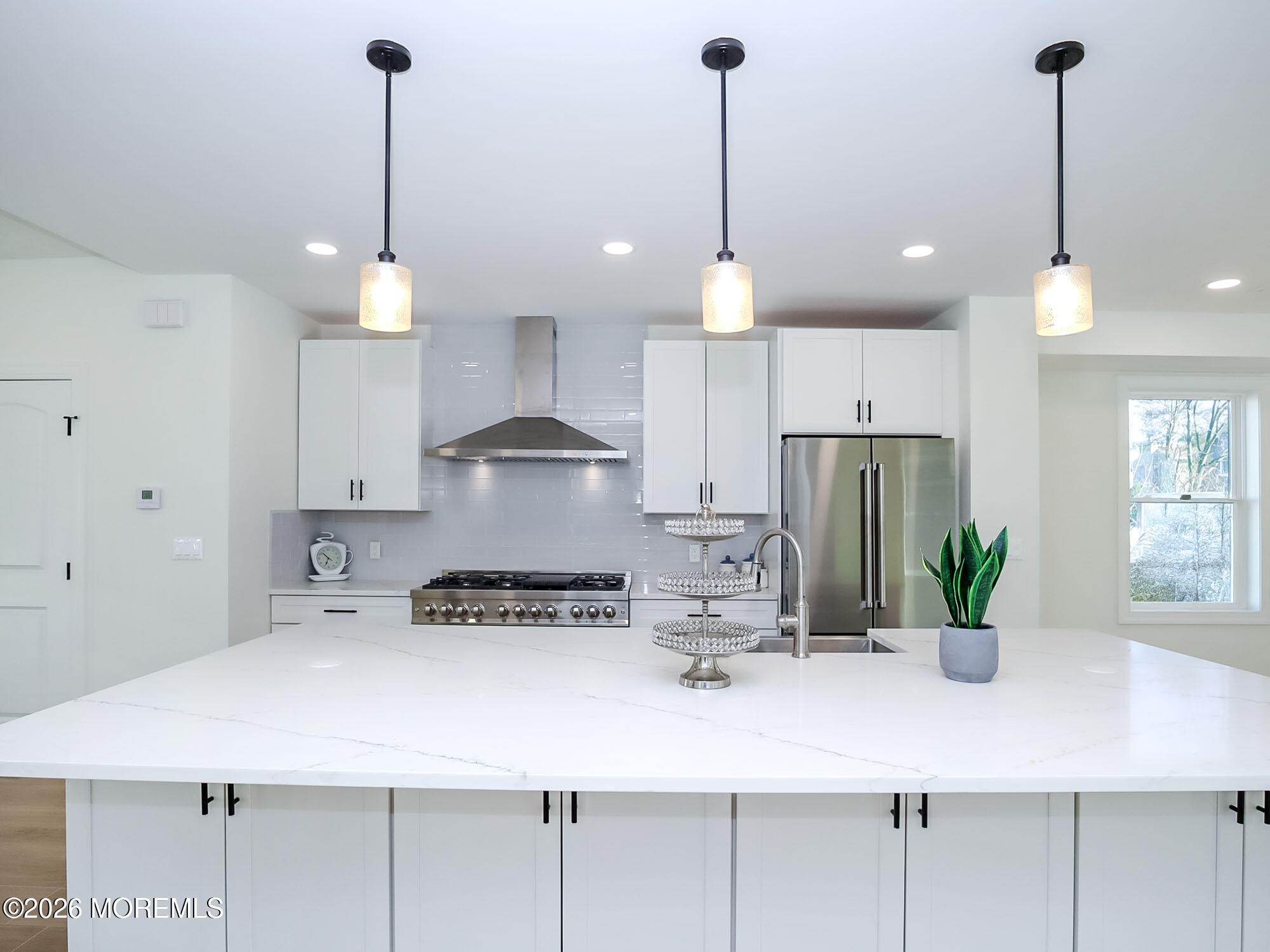 22 Marion Street Red Bank, NJ 07701 - Photo 16 of 50 a kitchen with stainless steel appliances kitchen island granite countertop a sink a stove and a wooden floors