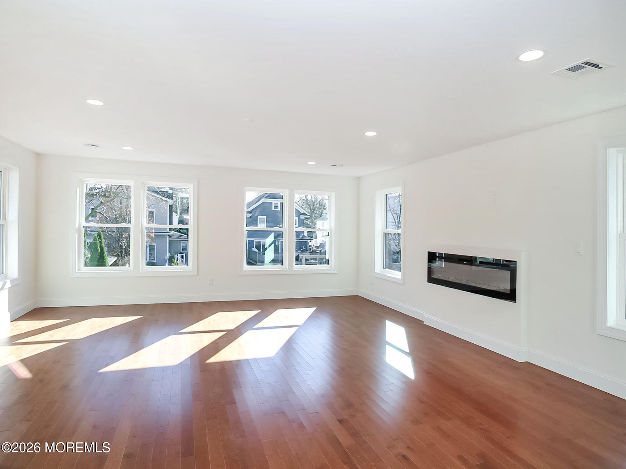 22 Marion Street Red Bank, NJ 07701 - Photo 38 of 50 a view of an empty room with wooden floor and a window