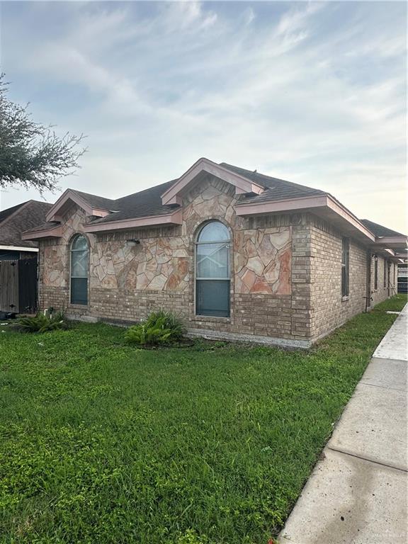 3703 South Radisson Avenue, Unit 3 Pharr, TX 78577 - Photo 1 of 11 a front view of a house with a garden