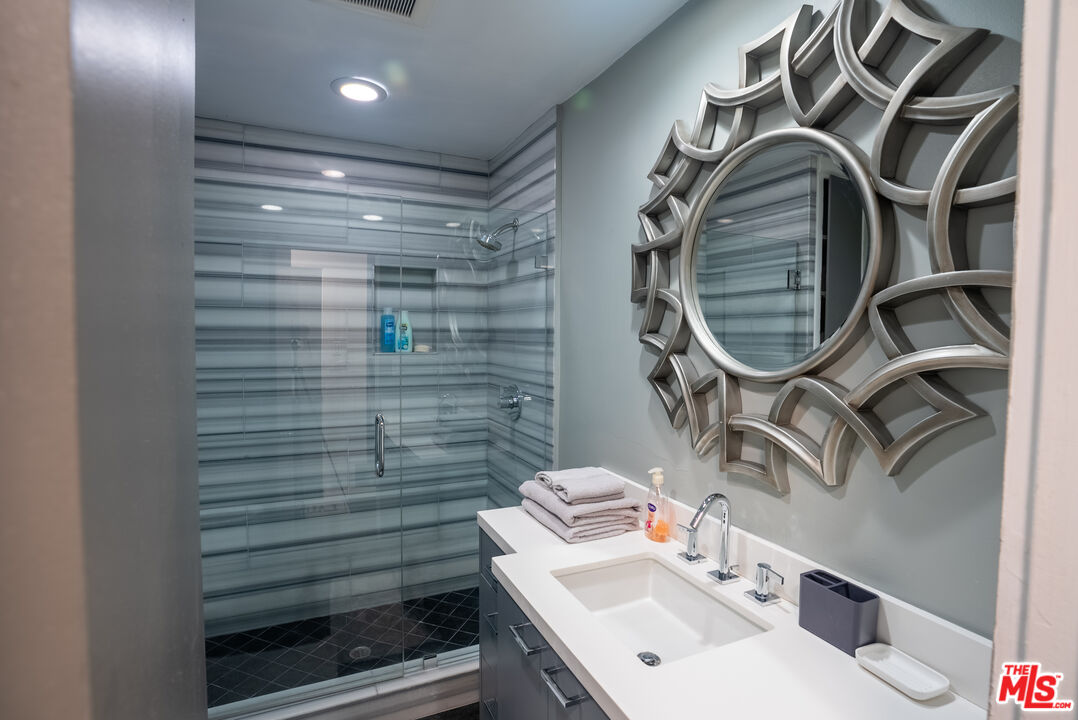 1438 Davies Drive Beverly Hills, CA 90210 - Photo 11 of 16 a bathroom with a sink and a mirror