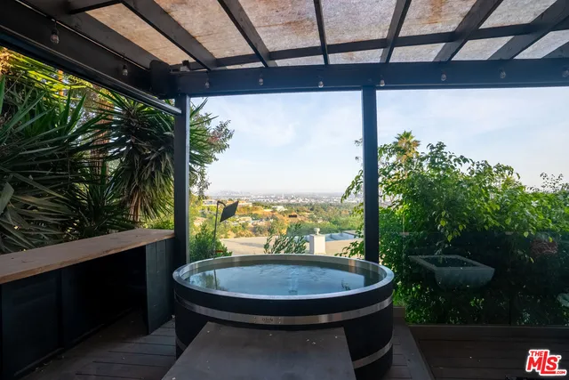 a view of a porch with furniture and a yard