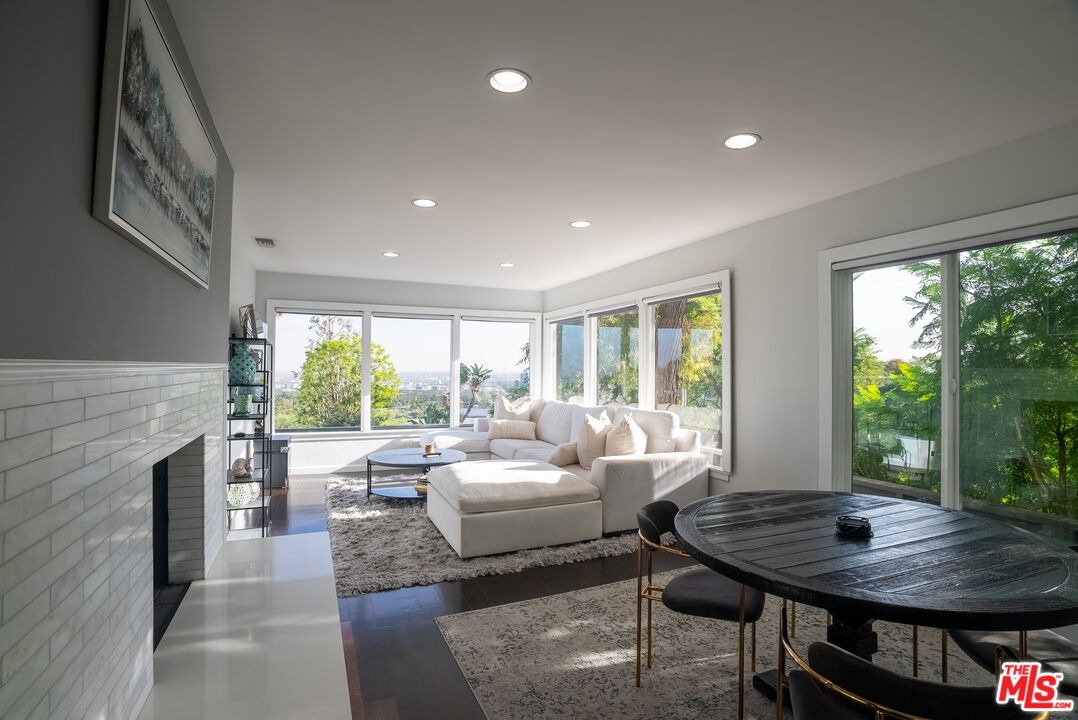 1438 Davies Drive Beverly Hills, CA 90210 - Photo 2 of 16 a living room with fireplace furniture and a large window