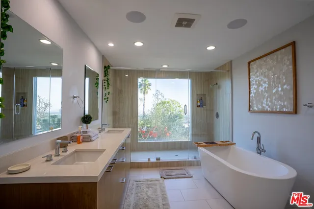 a bathroom with a bathtub a sink and a window