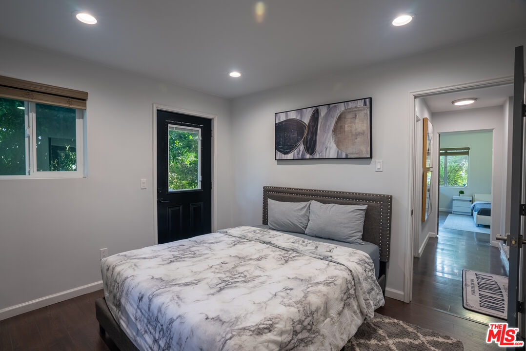 1438 Davies Drive Beverly Hills, CA 90210 - Photo 8 of 16 a bedroom with a large bed and a window