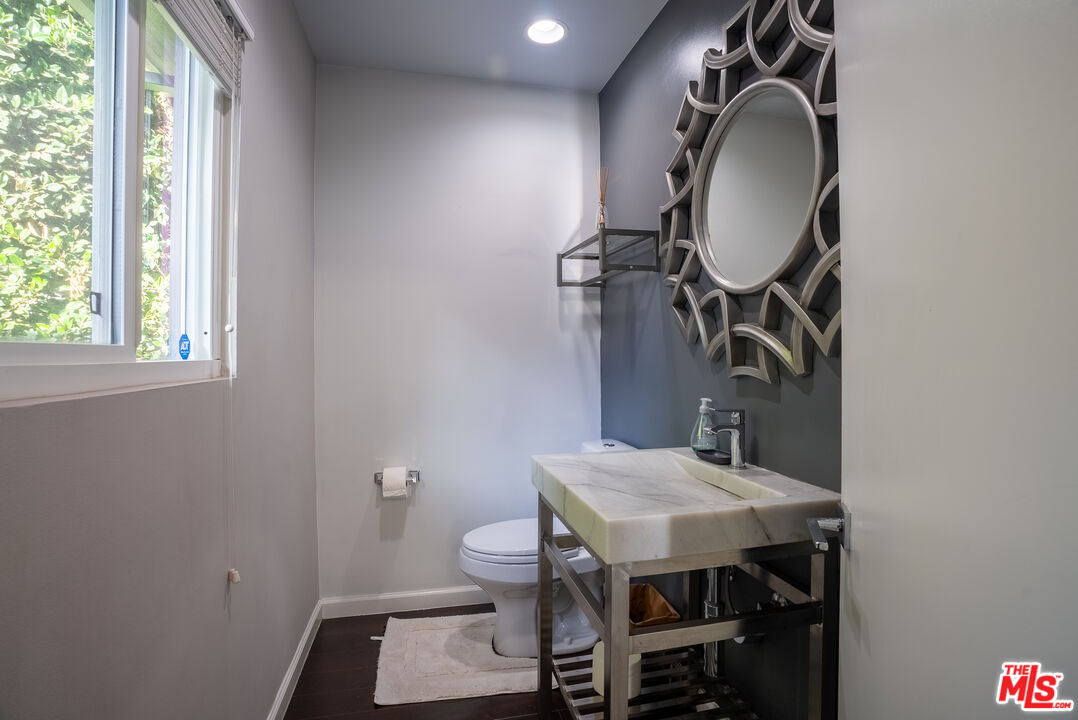1438 Davies Drive Beverly Hills, CA 90210 - Photo 9 of 16 a bathroom with a sink a mirror and a toilet