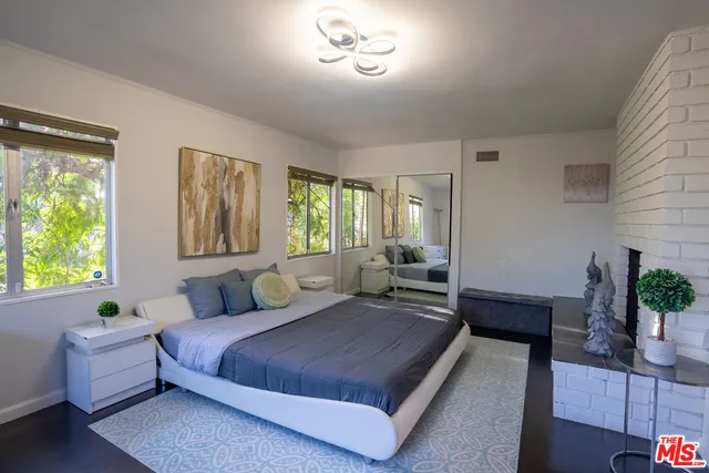 a spacious bedroom with a bed and a couch