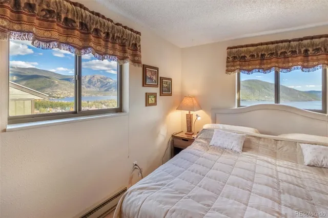 a bed room with a bed and a large window