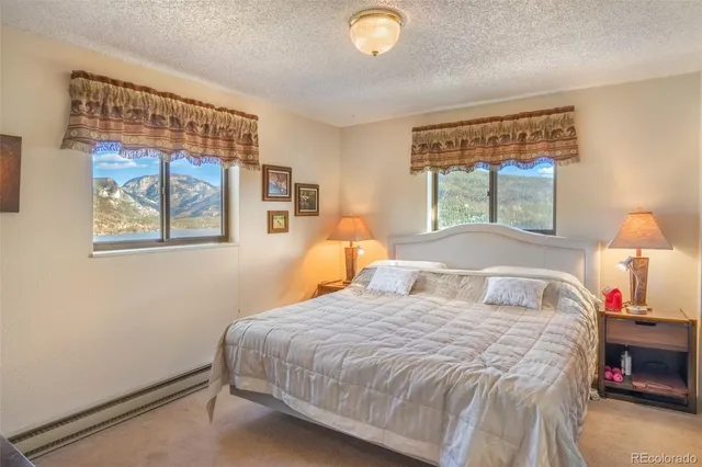 a bedroom with a bed and a painting on the wall