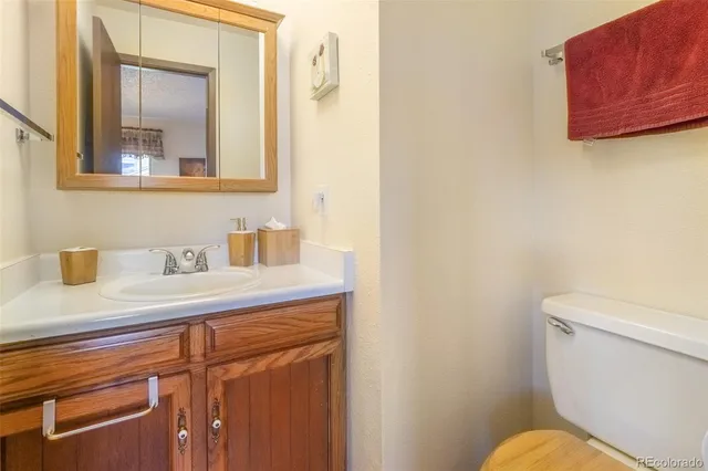 a bathroom with a sink a mirror and a toilet