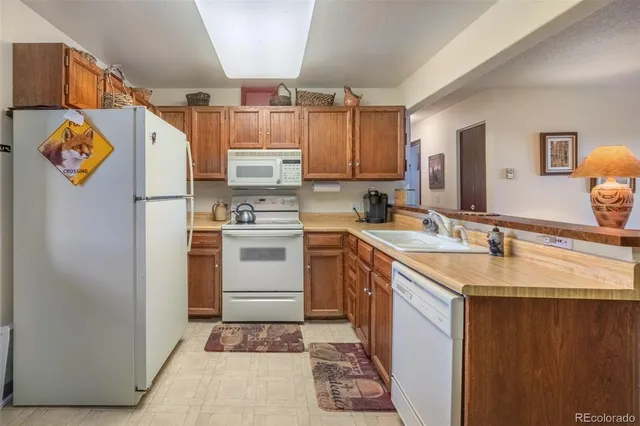 a kitchen with a sink stove and refrigerator
