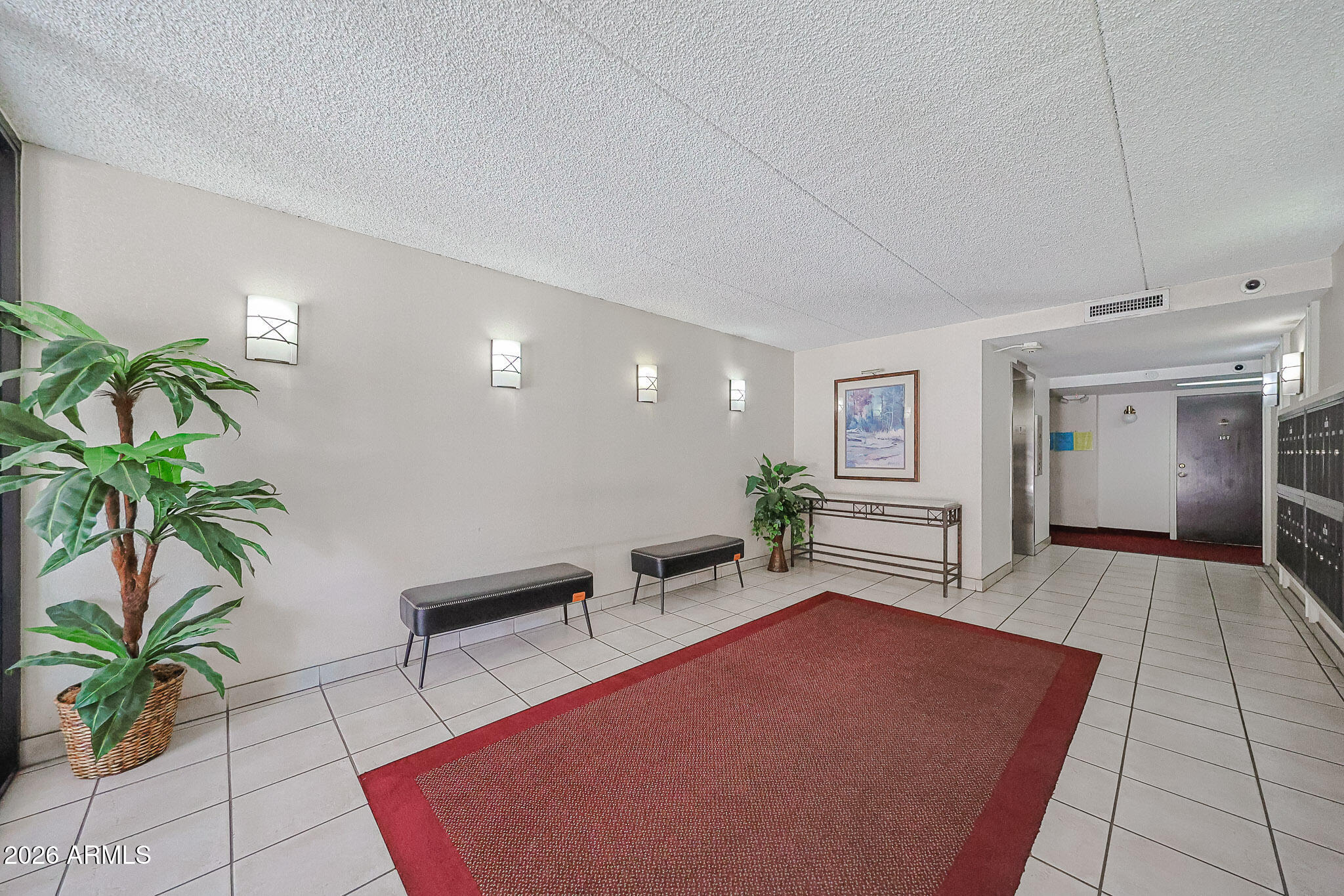 7920 East Camelback Road, Unit 111 Scottsdale, AZ 85251 - Photo 4 of 32 a living room with furniture and a potted plant