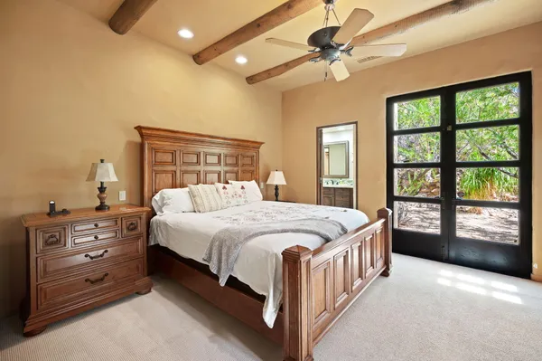 a bedroom with a bed and a dresser with mirror