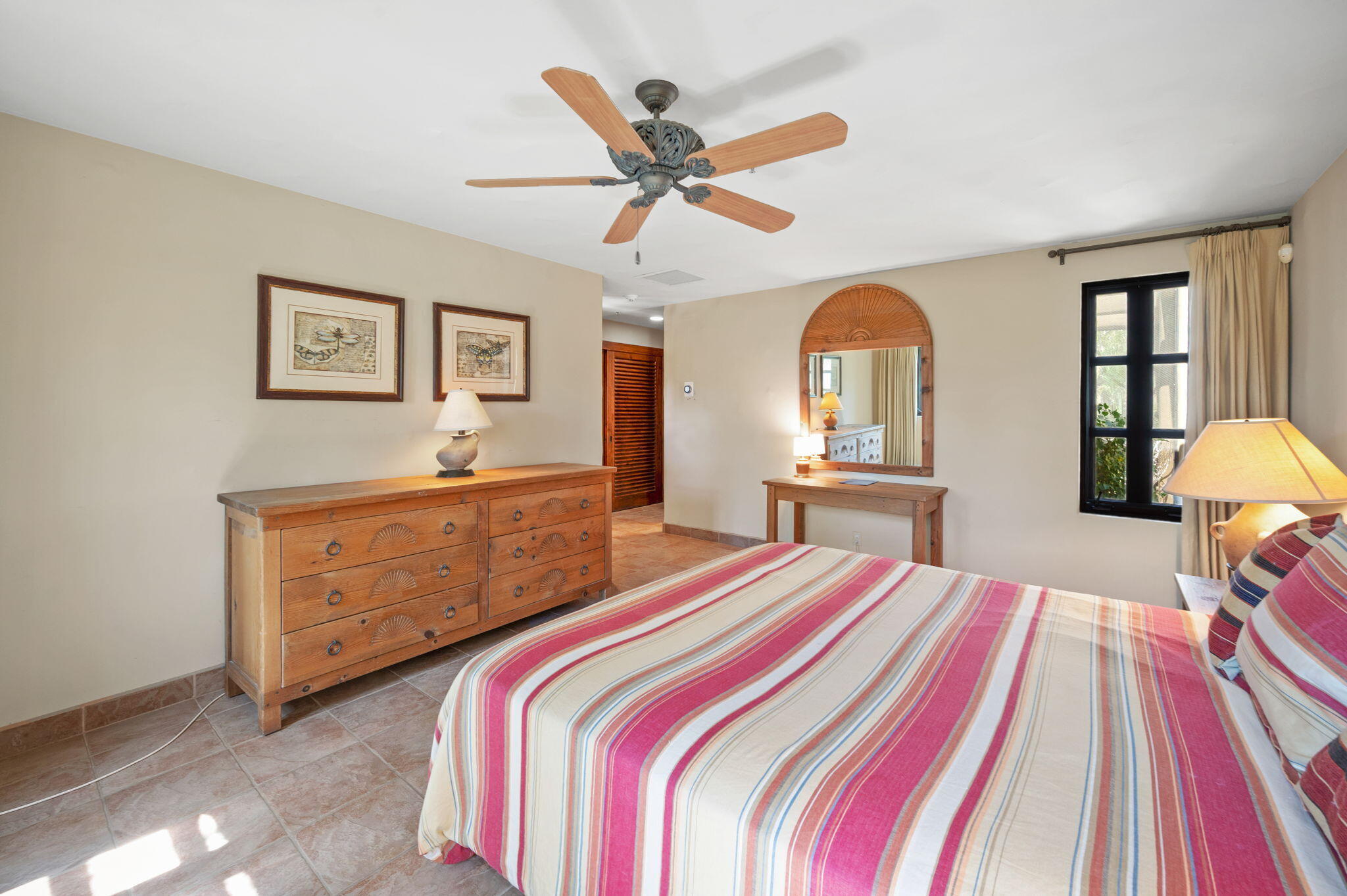 72275 Upper Way West Palm Desert, CA 92260 - Photo 56 of 68 a bedroom with a bed and a dresser with mirror