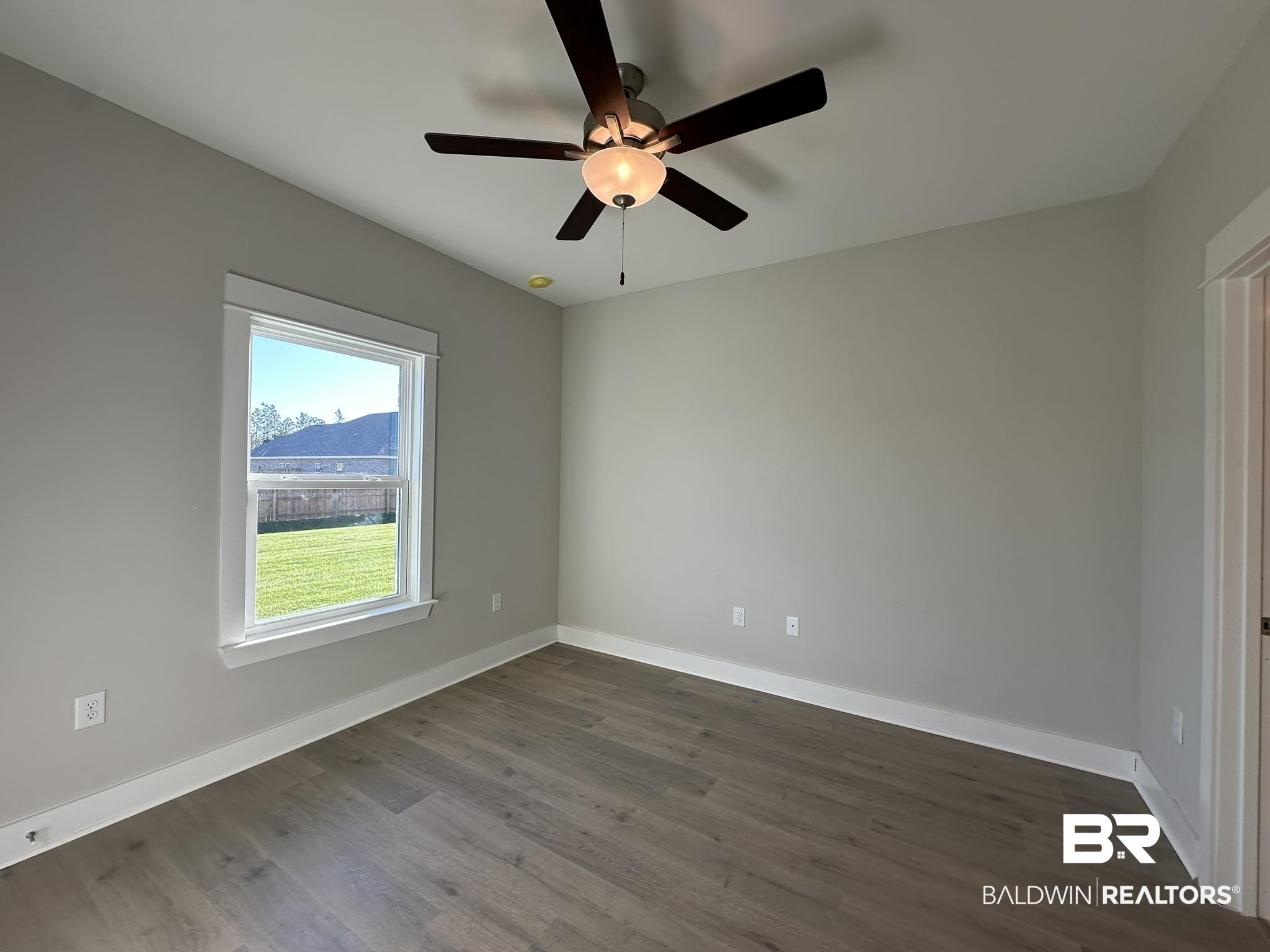 23582 Travis Stock Street, Unit 48 Foley, AL 36535 - Photo 20 of 51 Unfurnished room with dark hardwood / wood-style floors and ceiling fan