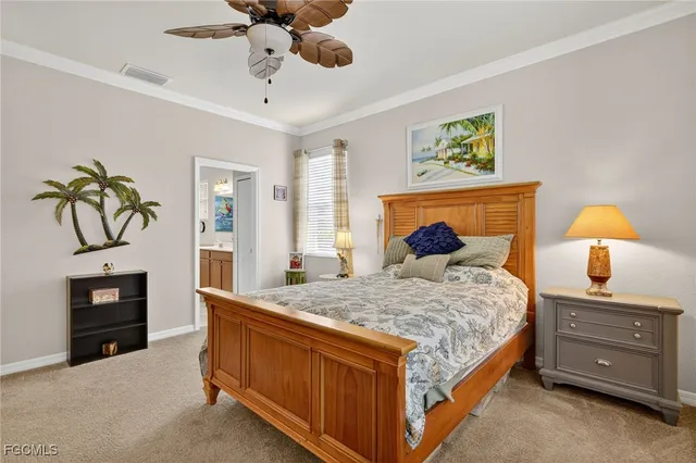 a bedroom with a bed a dresser and painting on the wall