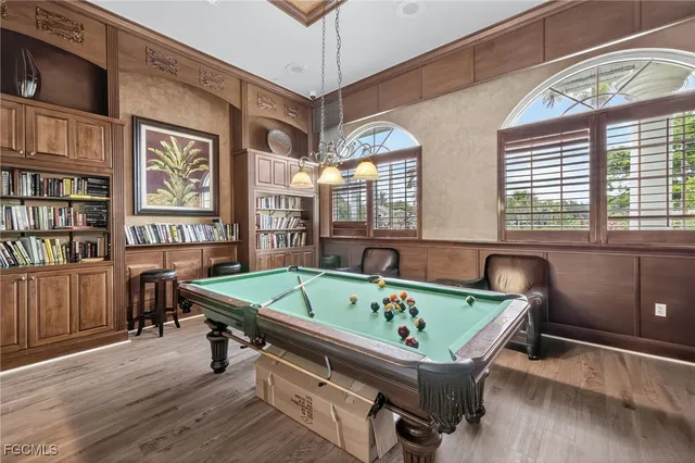 a room with furniture pool table and windows