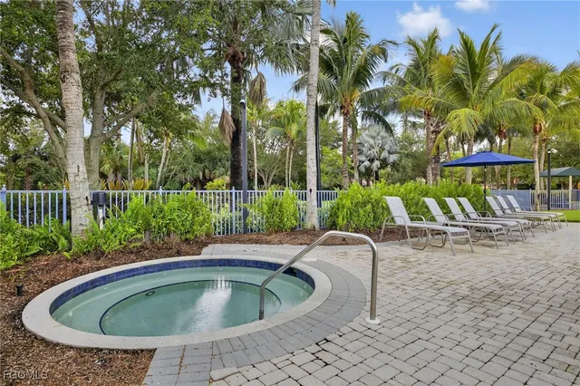 a view of backyard with swimming pool and outdoor seating