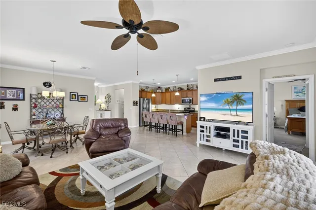 a living room with furniture kitchen view and a window