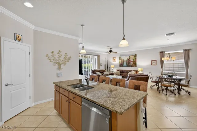 a kitchen with center island table and chairs