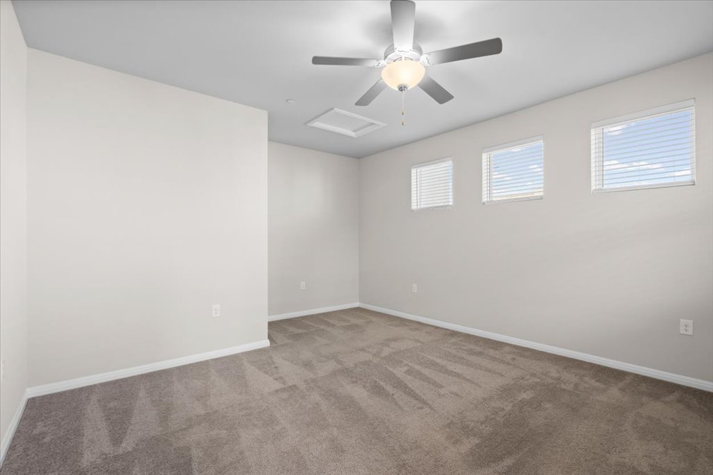 9015 Cattle Baron Path, Unit 705 Austin, TX 78747 - Photo 18 of 35 en empty room with windows and ceiling fan