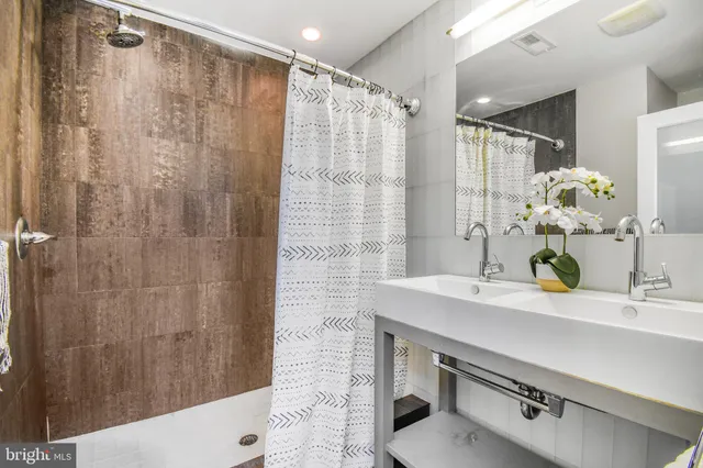 a bedroom with a bed and a potted plant