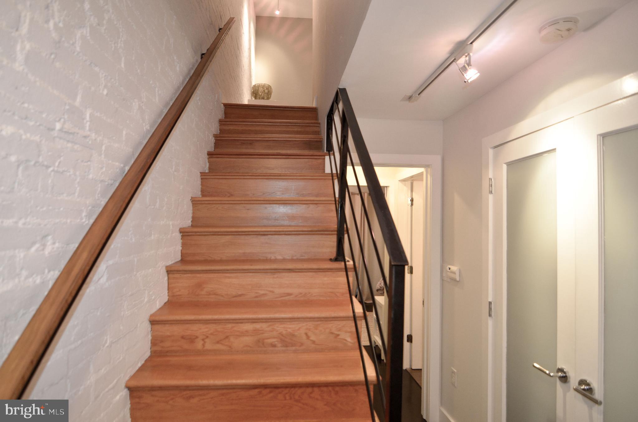 1538 Swann Street Northwest Washington, DC 20009 - Photo 23 of 37 Unit 1 - Lower Level Hall, Exposed Brick