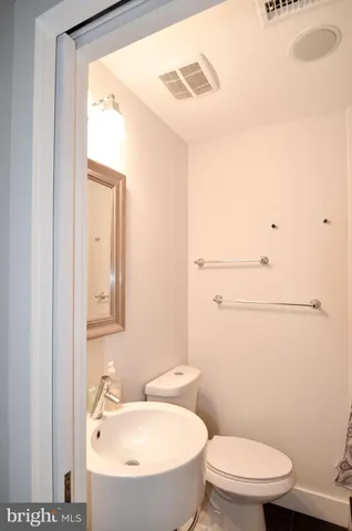 a bedroom with a bed and a night stand