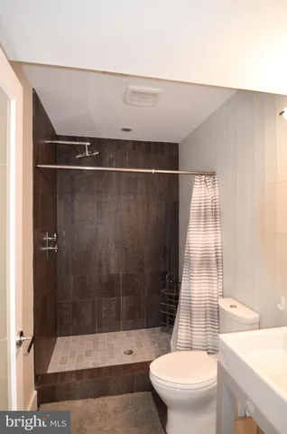 a bedroom with a bed mirror and a window