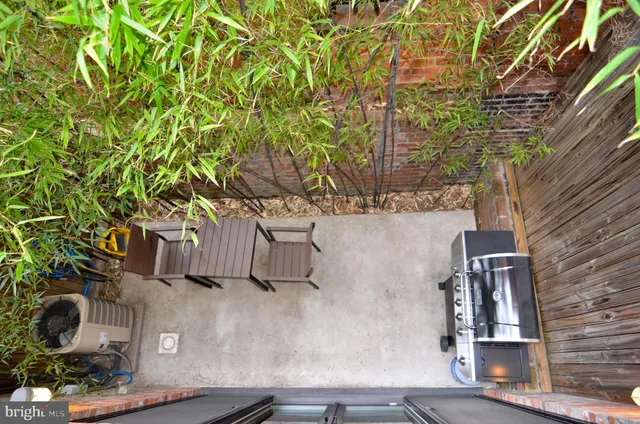 a view of a balcony with wooden floor and furniture