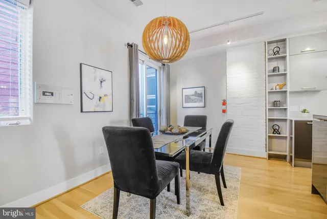 a view of a dining room with furniture and a chandelier