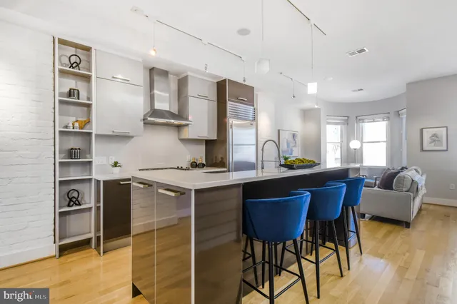a view of a dining room with furniture and a potted plant