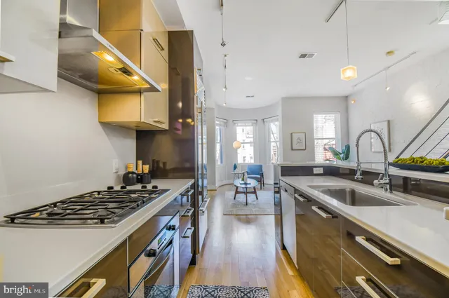 a kitchen with a table chairs refrigerator and wooden cabinets