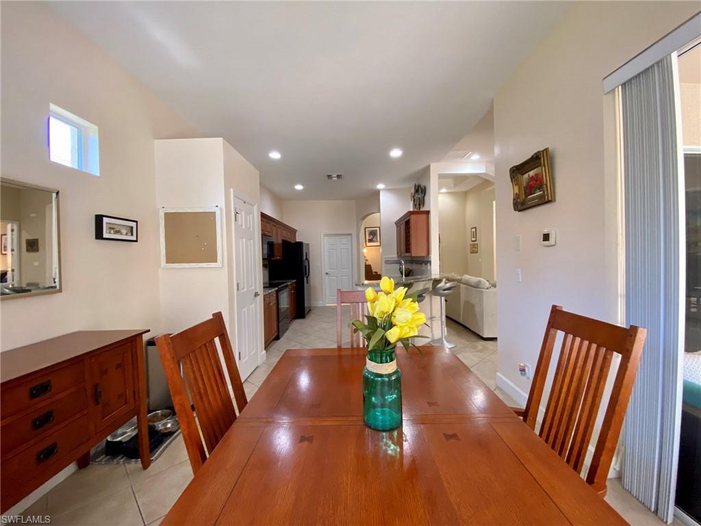 7806 Founders Circle Naples, FL 34104 - Photo 11 of 28 a living room with furniture and a flat screen tv