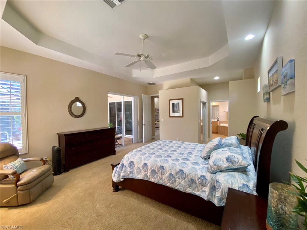 7806 Founders Circle Naples, FL 34104 - Photo 13 of 28 a bedroom with a bed dresser and a window