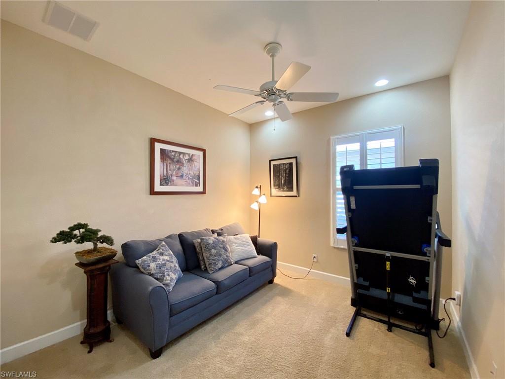 7806 Founders Circle Naples, FL 34104 - Photo 15 of 28 a living room with furniture and a flat screen tv