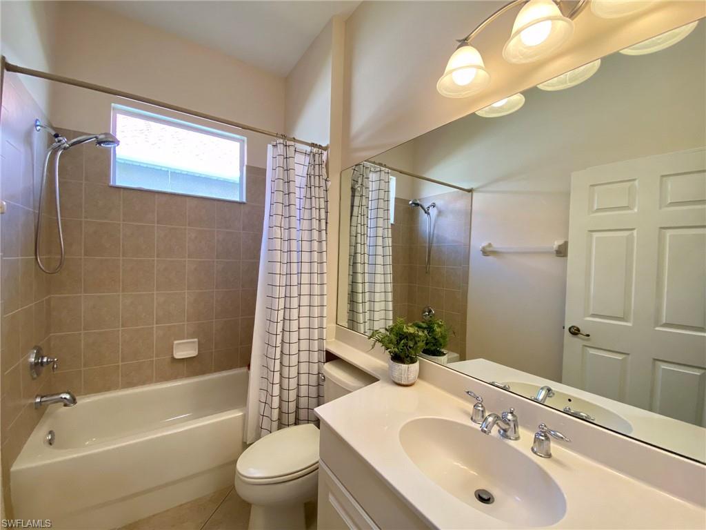 7806 Founders Circle Naples, FL 34104 - Photo 17 of 28 a bathroom with a sink a toilet and shower