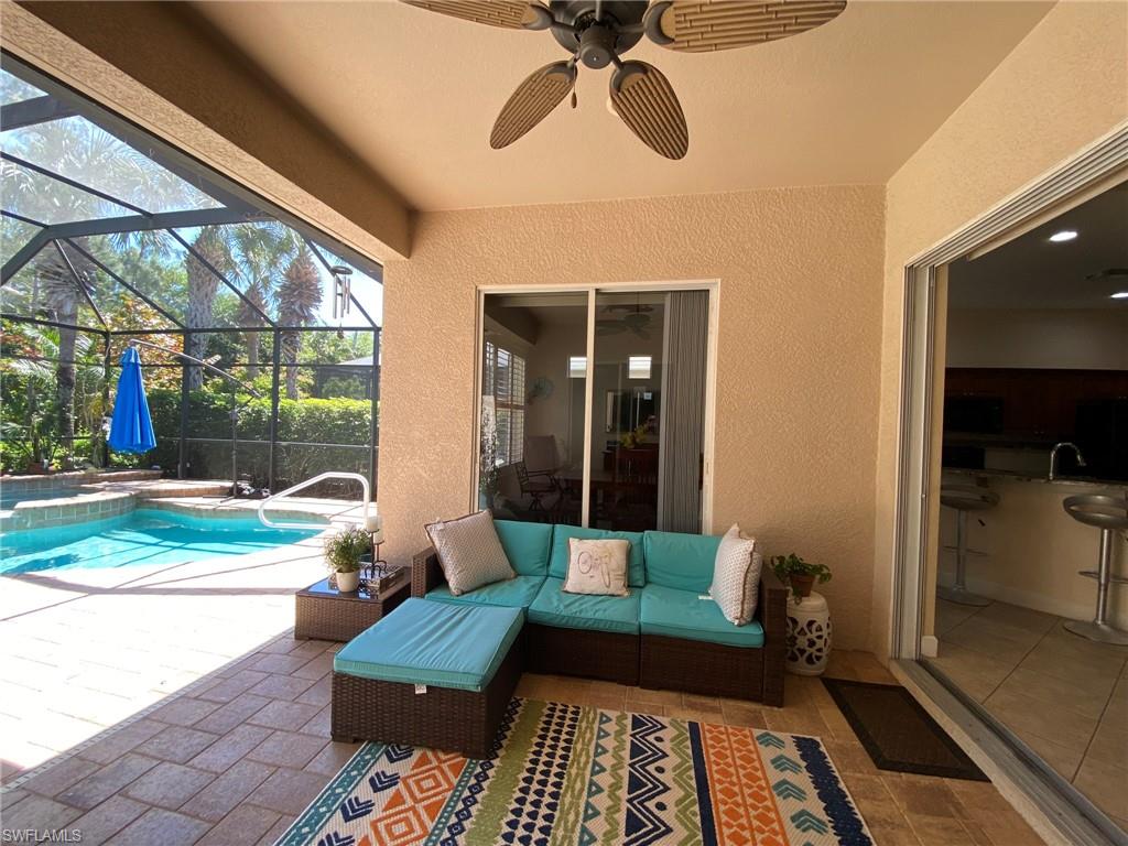 7806 Founders Circle Naples, FL 34104 - Photo 22 of 28 a balcony view with a couch and wooden floor