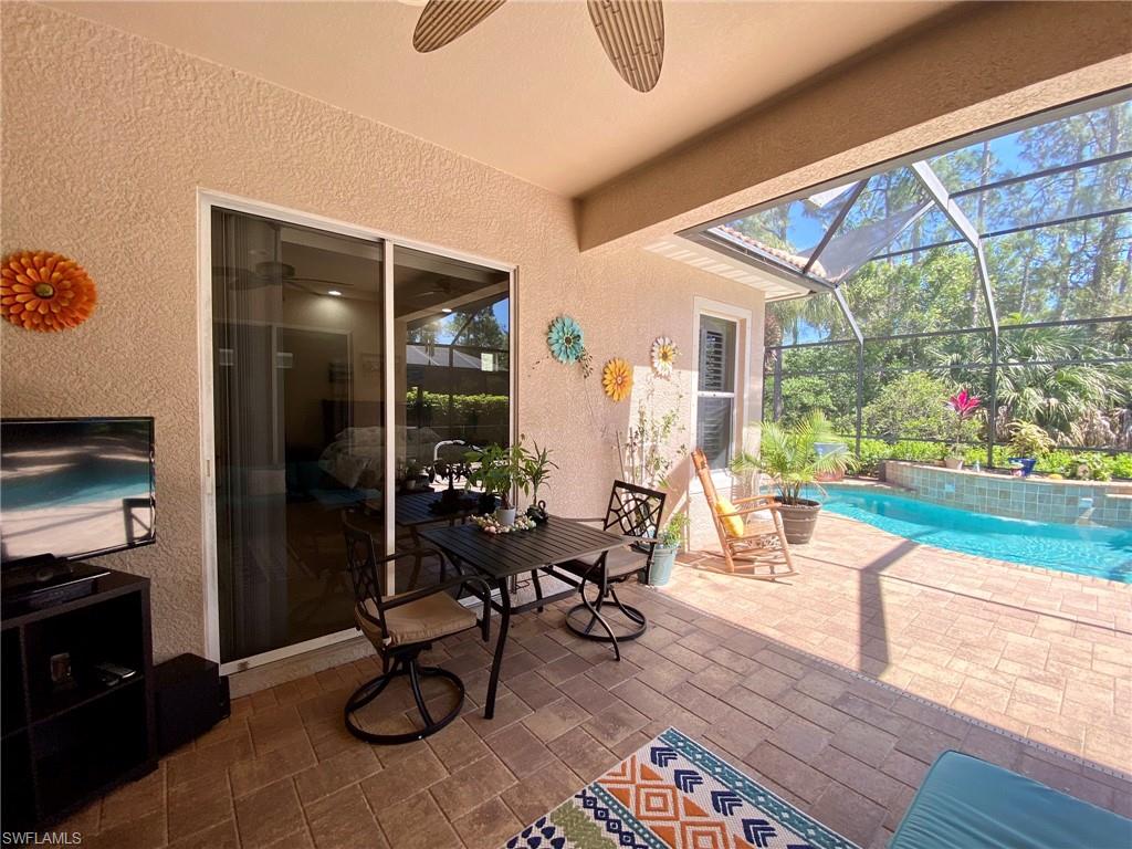7806 Founders Circle Naples, FL 34104 - Photo 23 of 28 a living room with furniture and a floor to ceiling window
