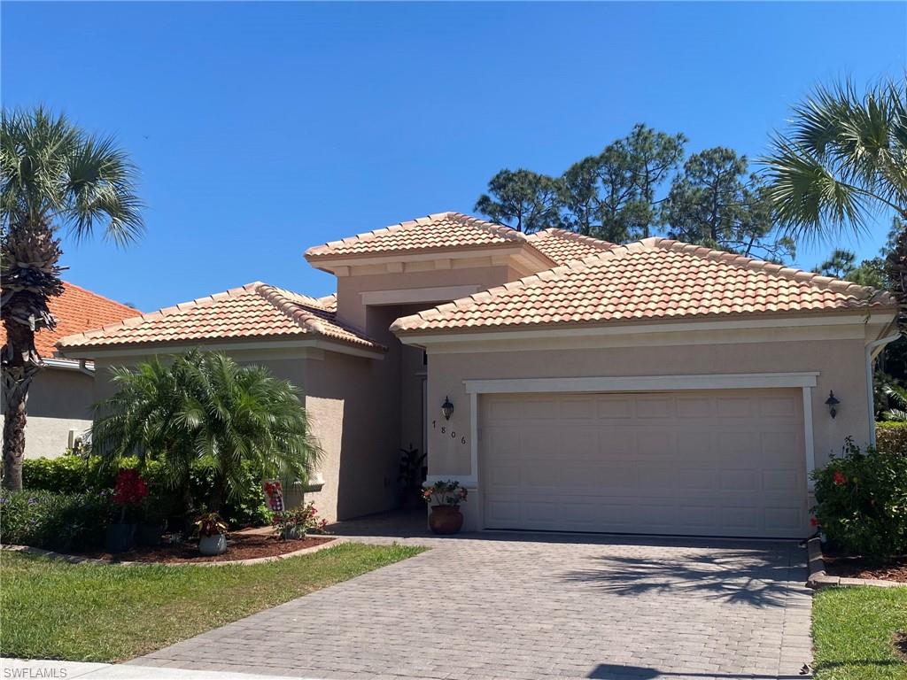 7806 Founders Circle Naples, FL 34104 - Photo 27 of 28 a front view of a house with a yard