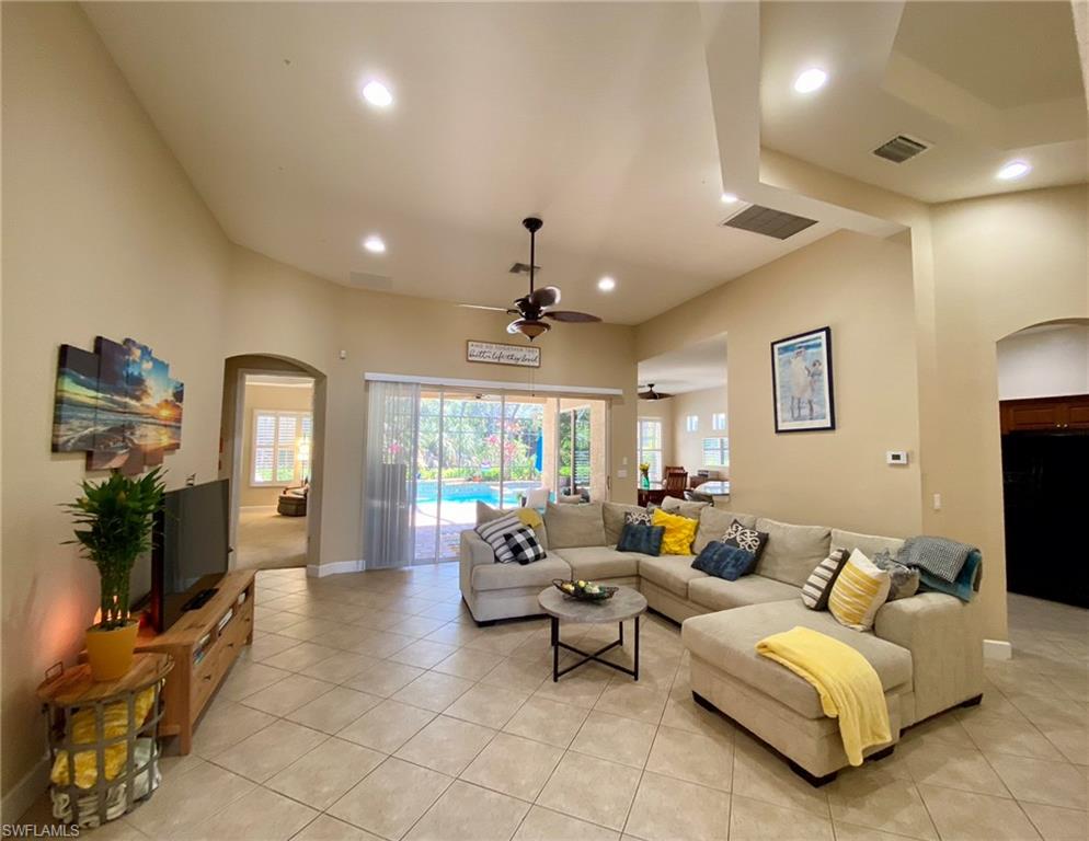 7806 Founders Circle Naples, FL 34104 - Photo 3 of 28 a living room with furniture and a flat screen tv