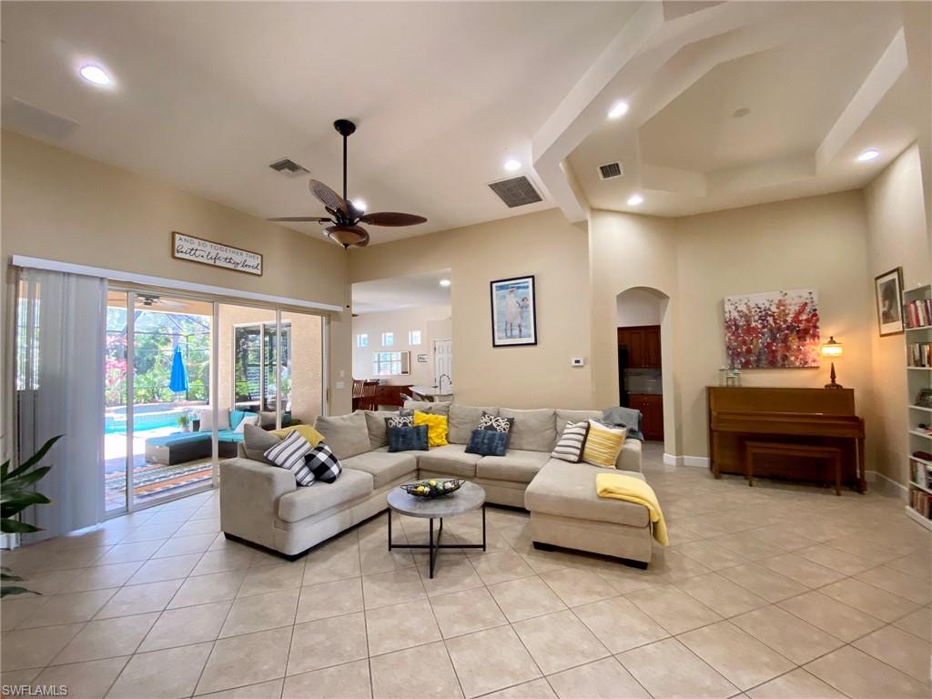 7806 Founders Circle Naples, FL 34104 - Photo 4 of 28 a living room with furniture and a chandelier