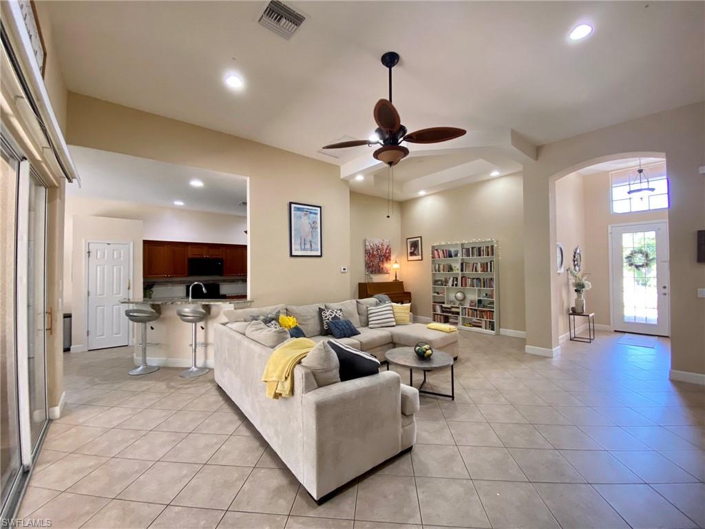 7806 Founders Circle Naples, FL 34104 - Photo 5 of 28 a living room with furniture and a flat screen tv